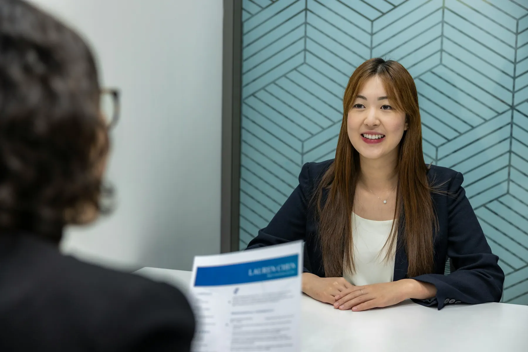A recruiter reviewing data on a laptop
