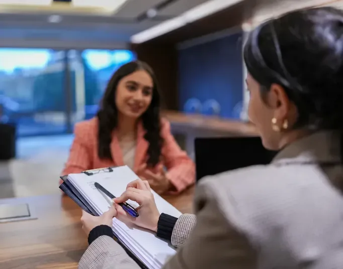 A recruiter taking notes during a candidate interview