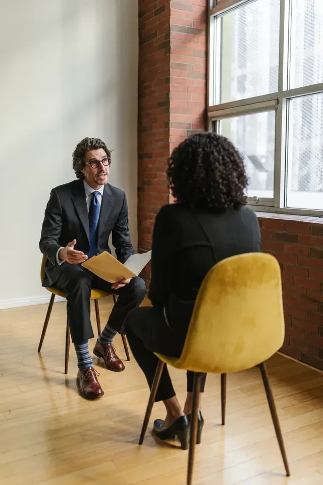 Two professionals having an interview beside a window